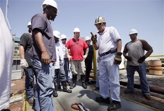 Instructor Ted Abshire, second from right, speaks to students during an oil rig training exercise in Morgan City, La. 